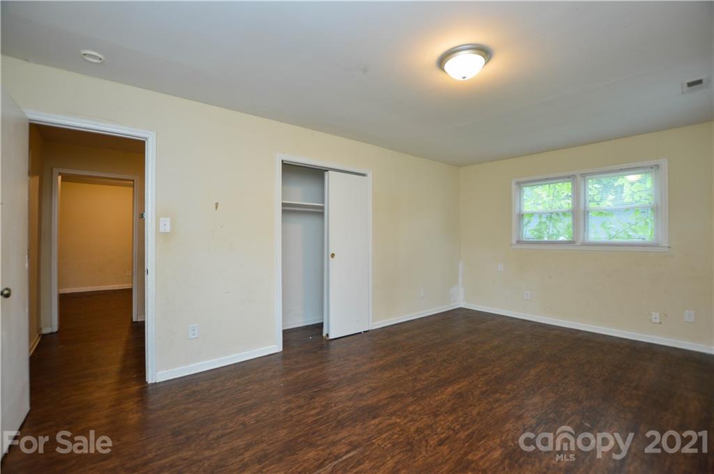 807 Squirrel Hill Road Charlotte, NC 28213 - Photo 16 of 34 a view of an empty room with wooden floor and a window
