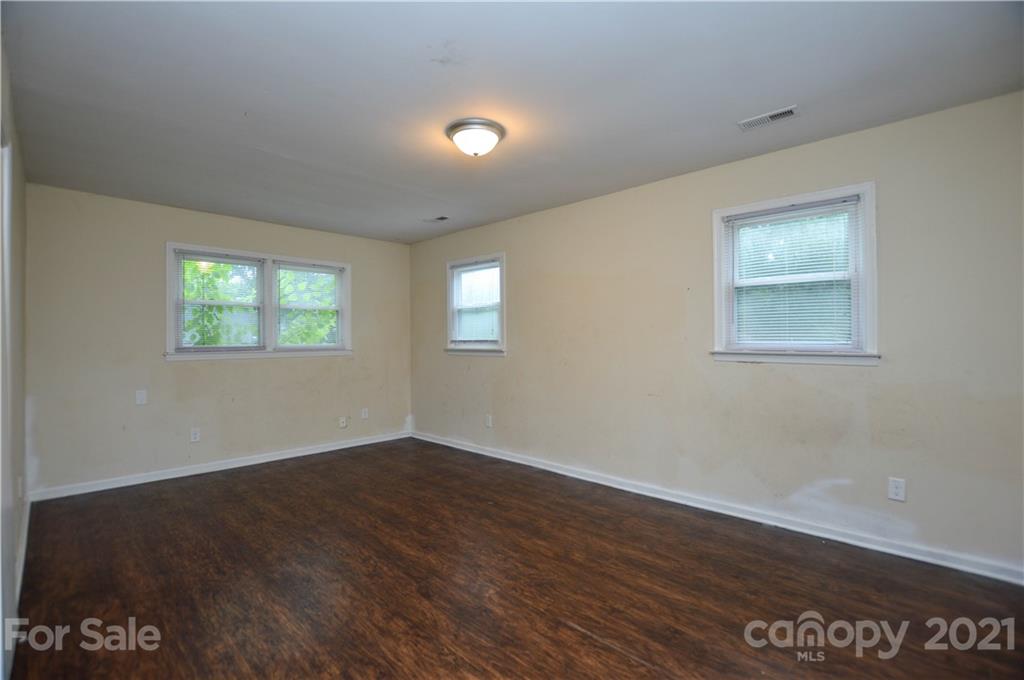 807 Squirrel Hill Road Charlotte, NC 28213 - Photo 17 of 34 a view of an empty room with wooden floor and a window