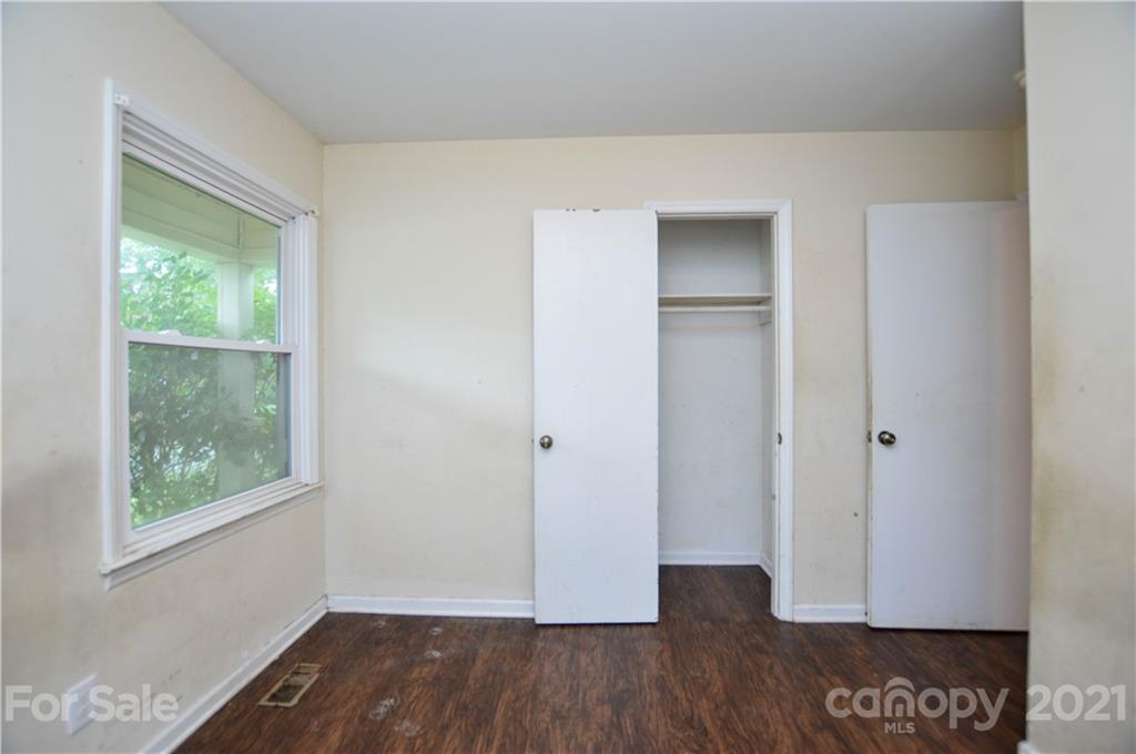 807 Squirrel Hill Road Charlotte, NC 28213 - Photo 21 of 34 a view of an empty room with wooden floor and a window