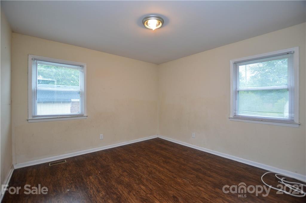 807 Squirrel Hill Road Charlotte, NC 28213 - Photo 25 of 34 a view of an empty room with wooden floor and a window