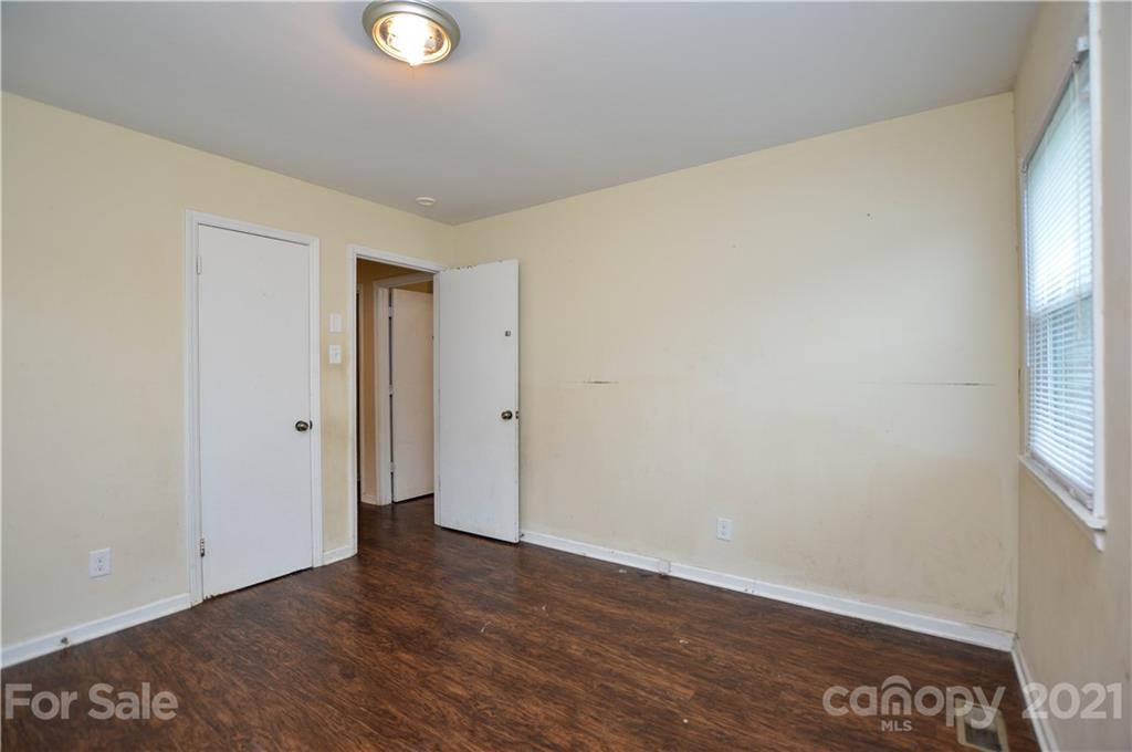 807 Squirrel Hill Road Charlotte, NC 28213 - Photo 27 of 34 a view of an empty room with wooden floor and a window