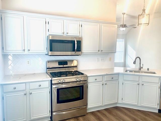 3912 Rushden Court Plano, TX 75025 - Photo 1 of 22 Contemporary style, gas burners, stainless steel appliances, subway backsplash, luxury plank flooriing, quartz countertops