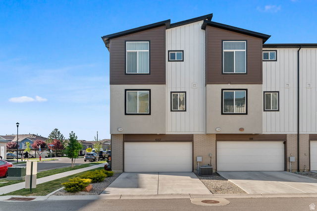 8307 Durham Street Sandy, UT 84070 - Photo 26 of 29 Modern multi-story townhouse exterior featuring a flat roofline and contrasting brown and white siding