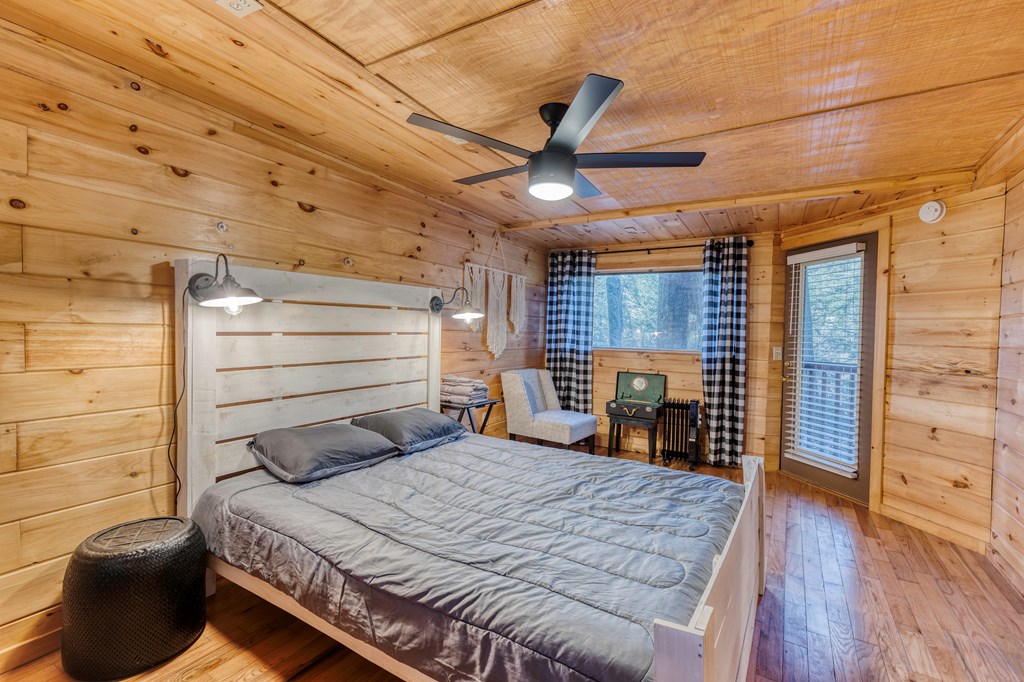 586 Newport Road Blue Ridge, GA 30513 - Photo 15 of 38 a bedroom with a bed and a large window