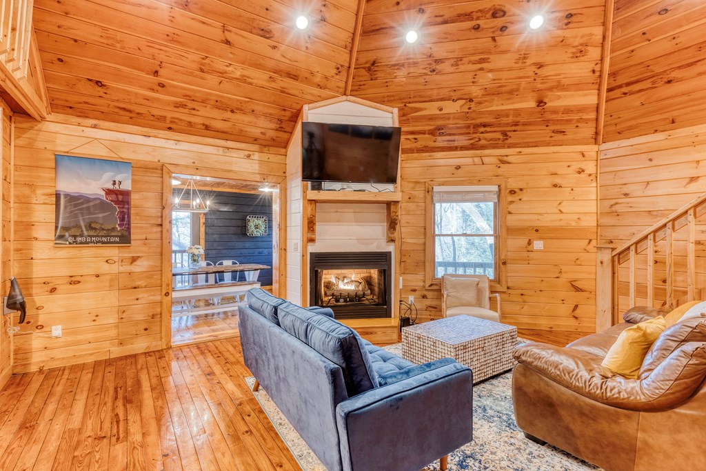 586 Newport Road Blue Ridge, GA 30513 - Photo 22 of 38 a living room with patio furniture and a fireplace