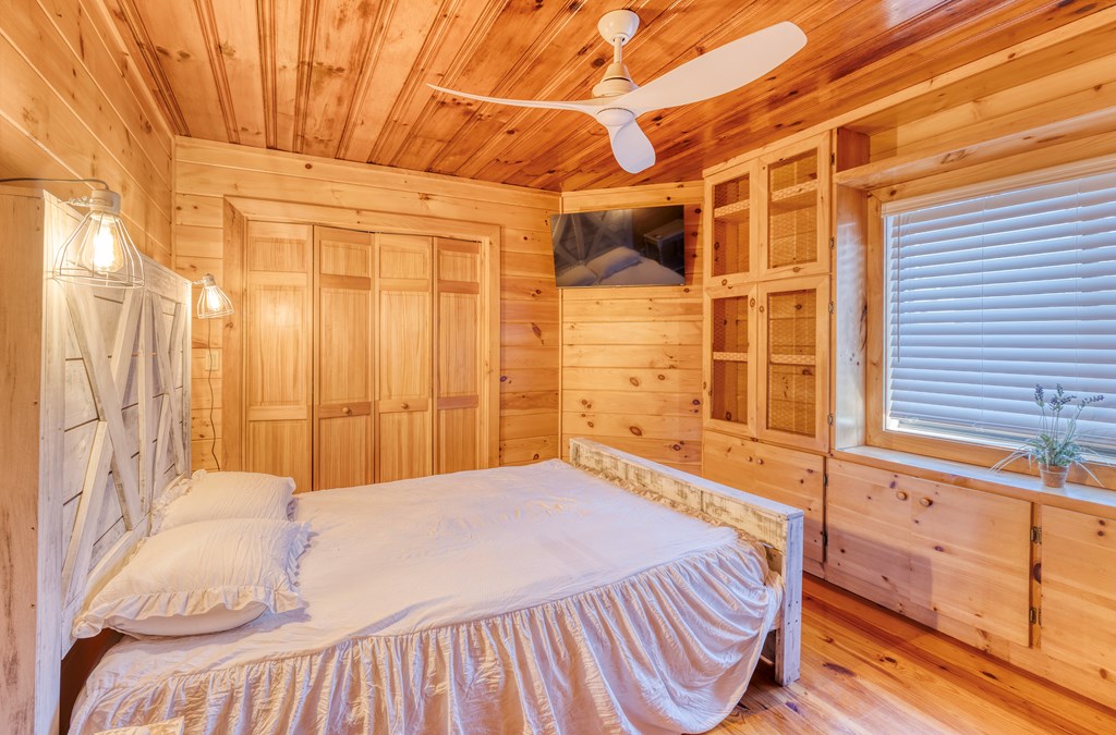 586 Newport Road Blue Ridge, GA 30513 - Photo 33 of 38 a bedroom with a bed and a window