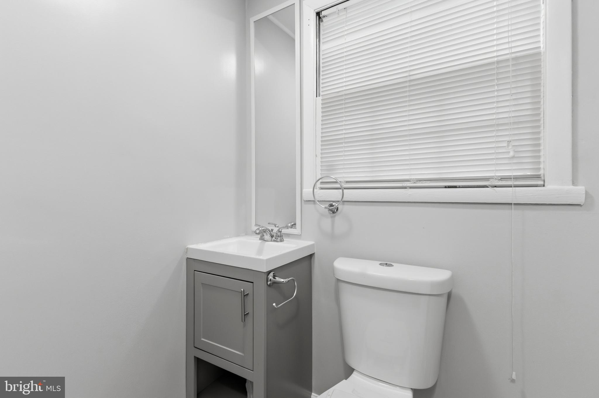 119 Jefferson Road Waldorf, MD 20602 - Photo 33 of 40 a bathroom with a toilet a sink and a window