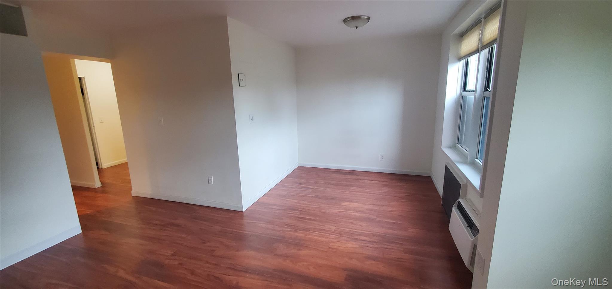 42 Pine Street, Unit 2E Yonkers, NY 10701 - Photo 11 of 24 an empty room with wooden floor and a window