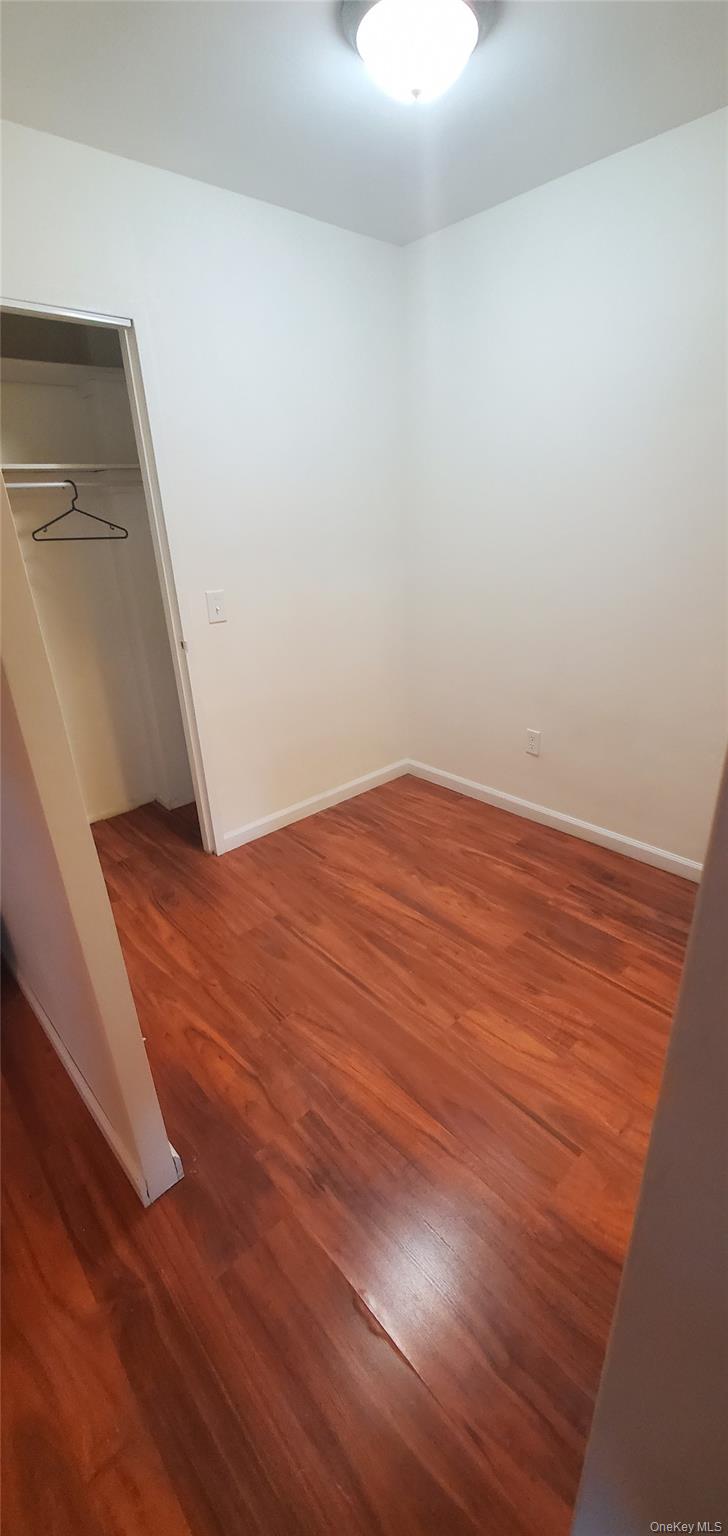 42 Pine Street, Unit 2E Yonkers, NY 10701 - Photo 12 of 24 a view of an empty room with wooden floor