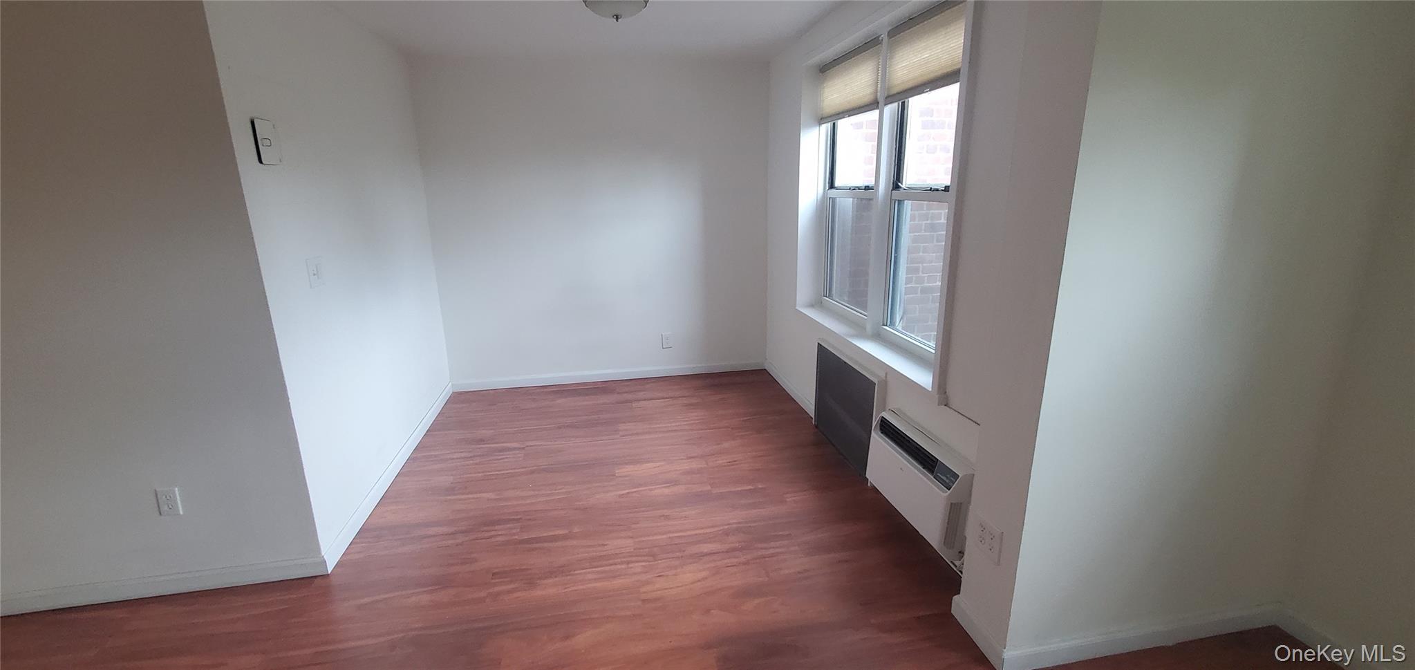 42 Pine Street, Unit 2E Yonkers, NY 10701 - Photo 21 of 24 a view of a hallway with wooden floor and staircase