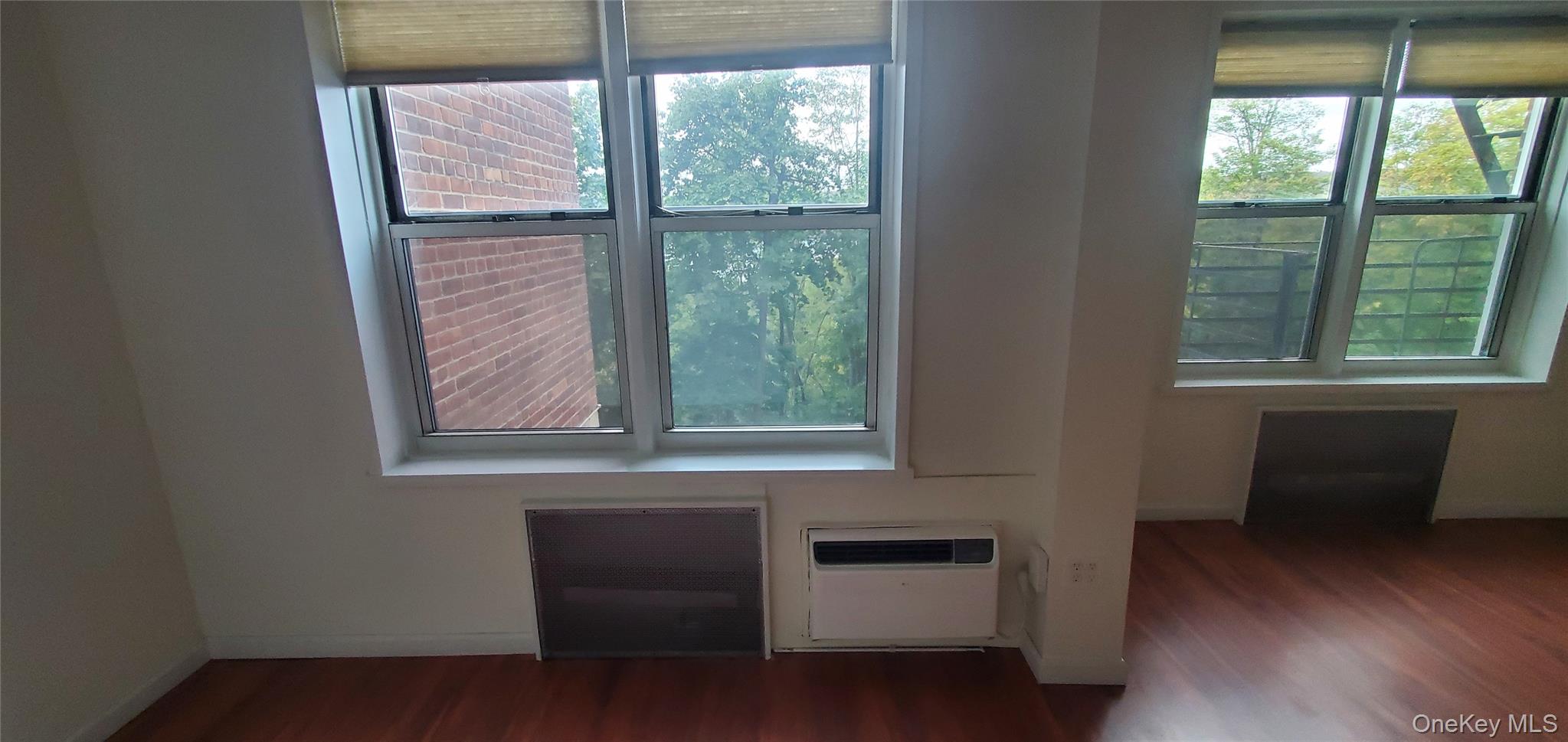 42 Pine Street, Unit 2E Yonkers, NY 10701 - Photo 22 of 24 a view of an empty room with wooden floor and a window