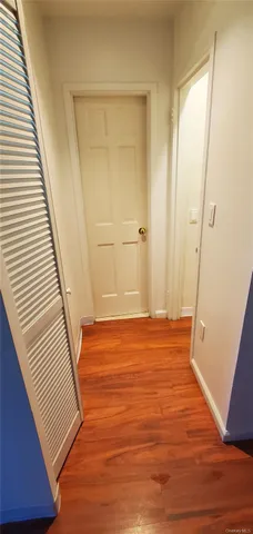 a view of a room with wooden floor and white walls