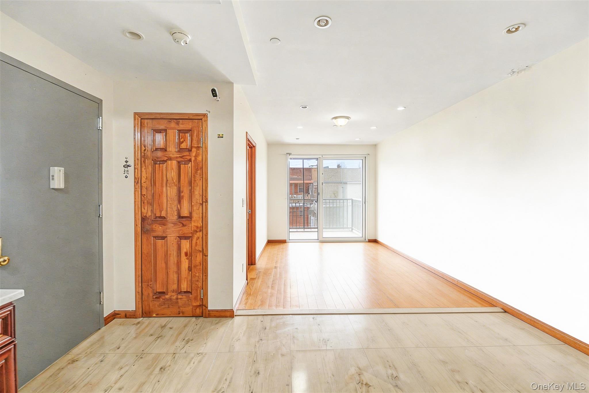 57-50 Granger Street, Unit 3A Queens, NY 11368 - Photo 3 of 20 a view of an empty room with wooden floor and a window