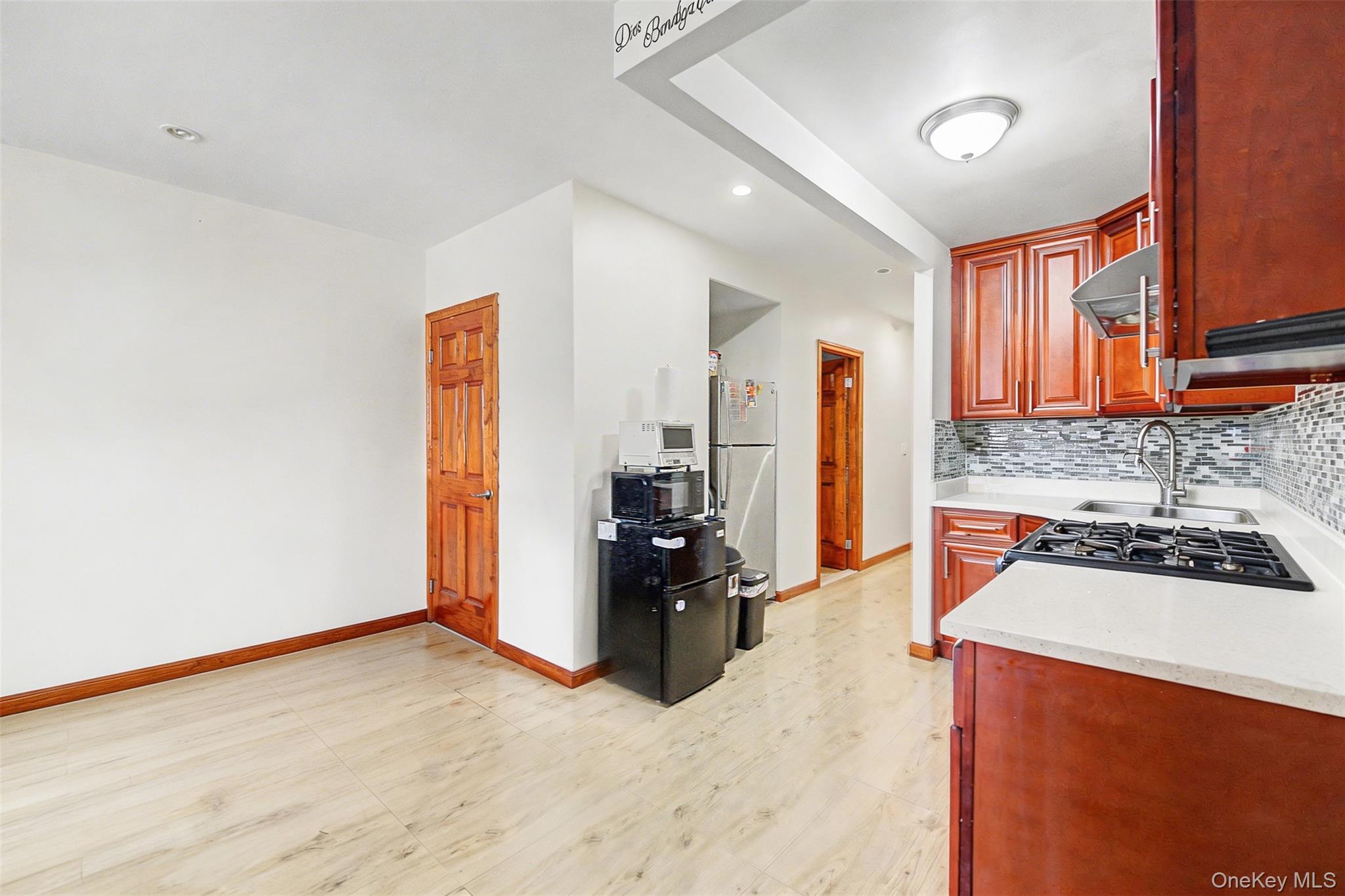 57-50 Granger Street, Unit 3A Queens, NY 11368 - Photo 6 of 20 Kitchen with backsplash, freestanding refrigerator, light stone countertops, and recessed lighting