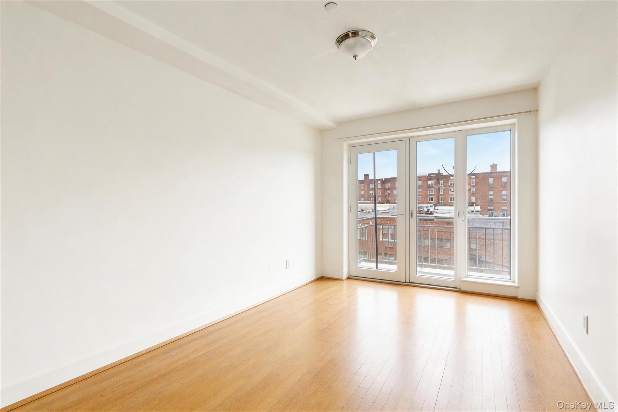 57-50 Granger Street, Unit 3A Queens, NY 11368 - Photo 9 of 20 Spare room with light wood finished floors and baseboards