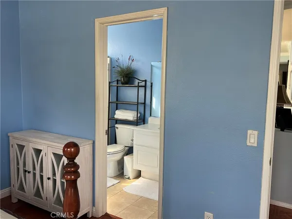 a bathroom with a toilet and a mirror
