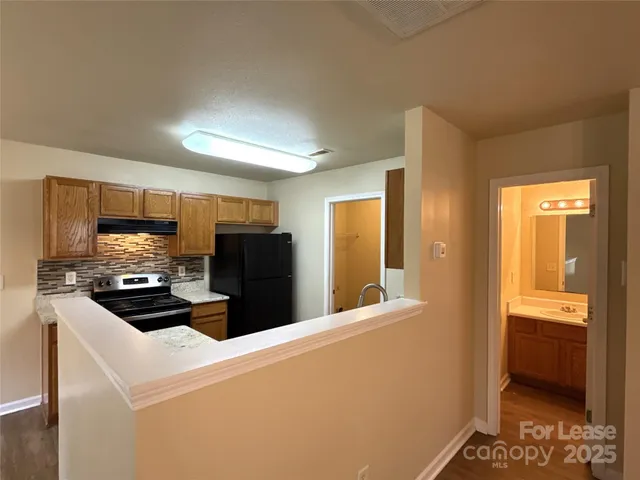 a kitchen with stainless steel appliances a refrigerator and a stove