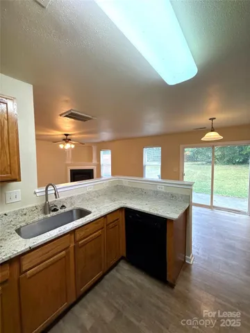a kitchen with stainless steel appliances granite countertop a sink and a stove