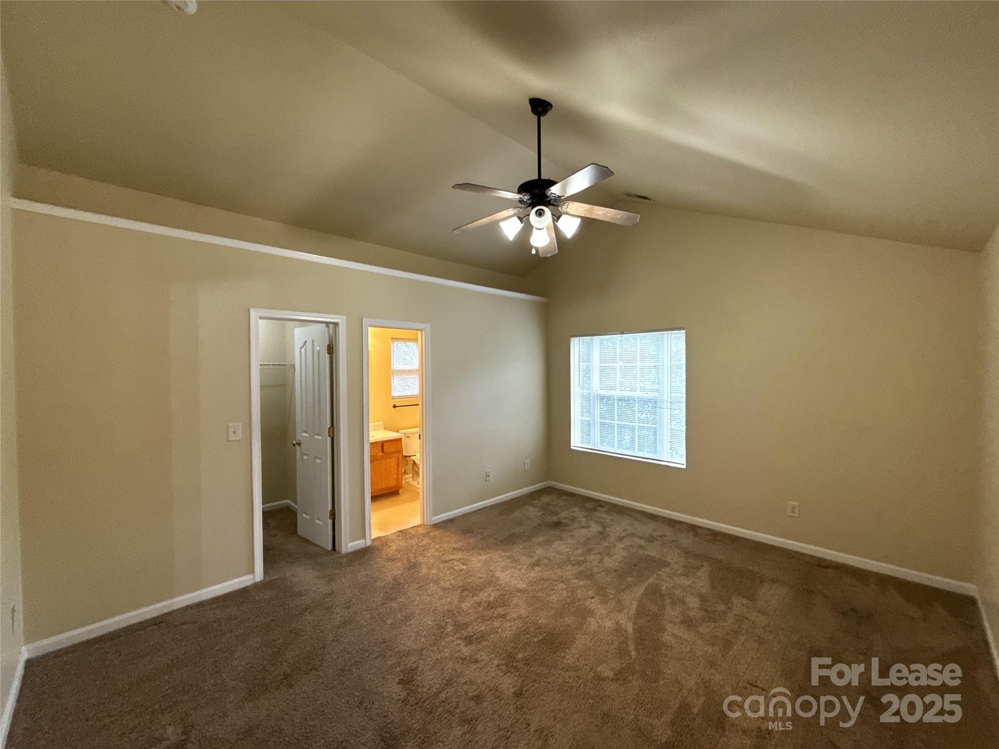 6831 Sunman Road Charlotte, NC 28216 - Photo 7 of 16 en empty room with windows and fan