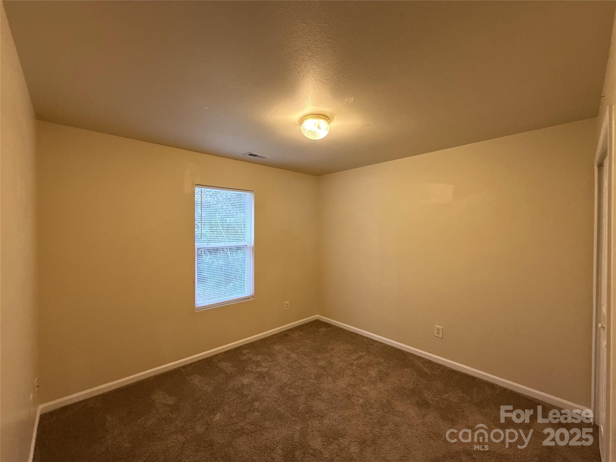 6831 Sunman Road Charlotte, NC 28216 - Photo 9 of 16 an empty room with a window