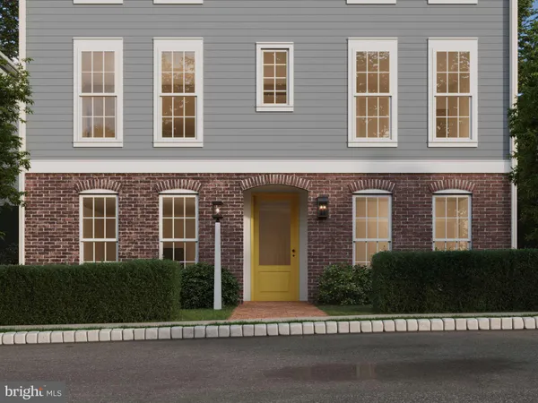 front view of a brick house and a yard