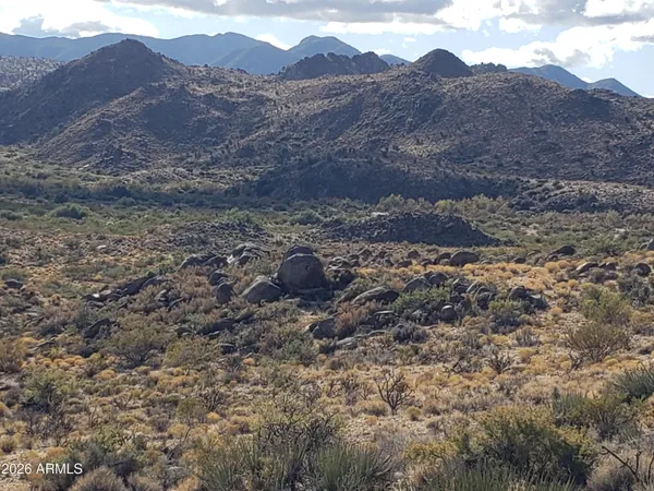a view of a dry mountains in the background