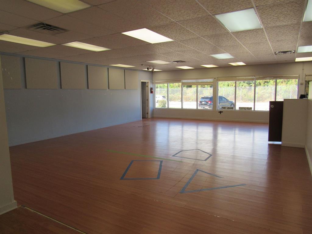 3208 Lebanon Church Road West Mifflin, PA 15122 - Photo 4 of 11 a view of an empty room with wooden floor and a window