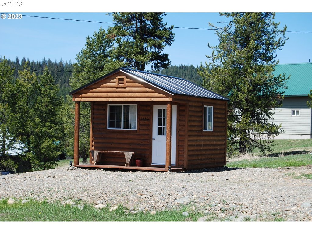 1442 Center Street Sumpter, OR 97877 - Photo 3 of 13 a front view of a house with a yard