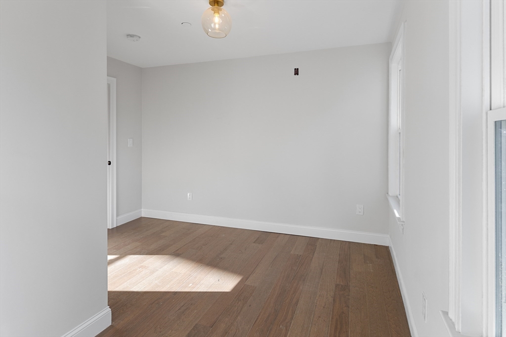 19 George Street, Unit 3 Somerville, MA 02145 - Photo 14 of 20 an empty room with wooden floor