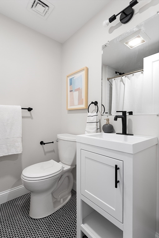 19 George Street, Unit 3 Somerville, MA 02145 - Photo 16 of 20 a bathroom with a sink toilet and a mirror