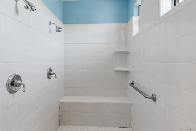 a bedroom with a bed and a potted plant