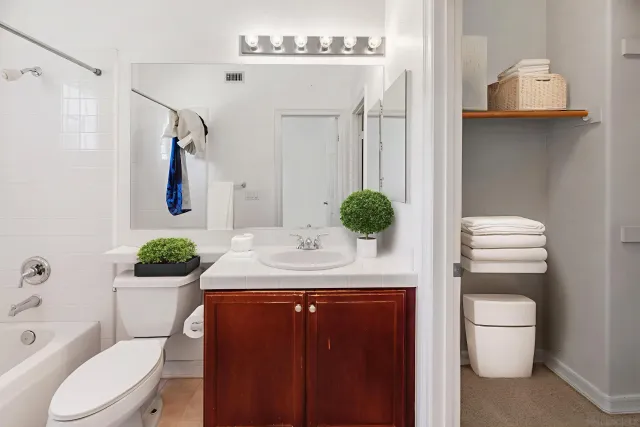 a view of a patio with table and chairs potted plants with wooden floor and fence