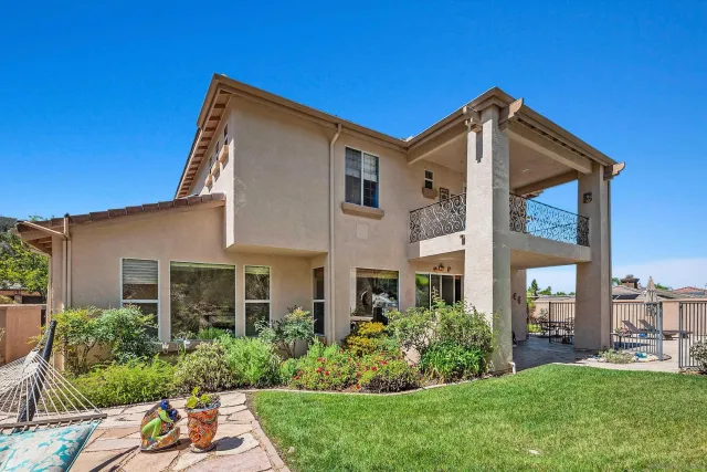 a view of a back yard with flower plants