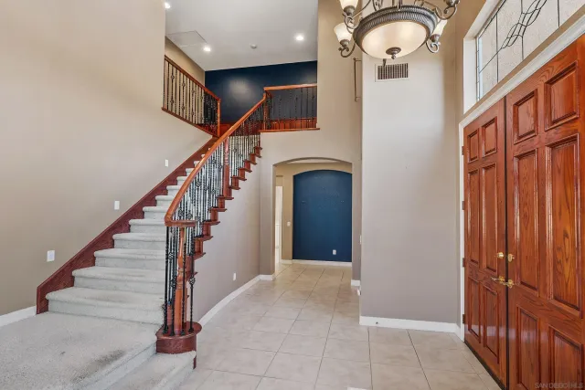 a living room with furniture fireplace and a large window