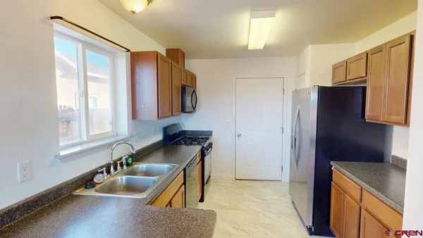 a kitchen with a refrigerator and a sink
