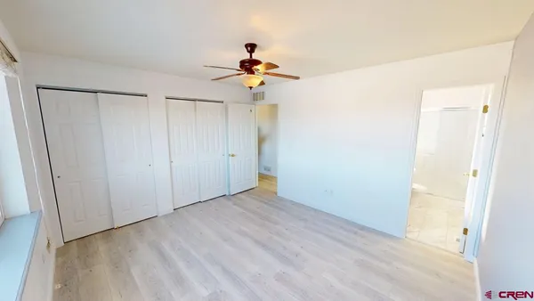 a view of a chandelier fan in a empty room