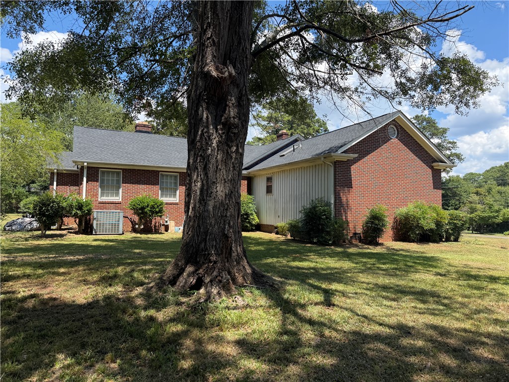 715 Concord Road Anderson, SC 29621 - Photo 7 of 24 Mature trees define this residence, offering privacy and traditional curb appeal.
