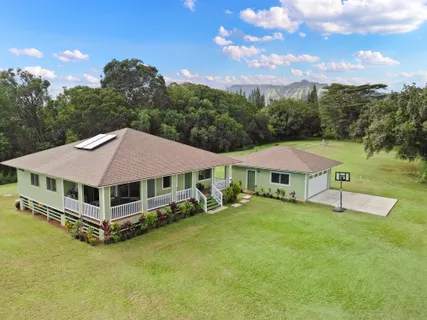 a aerial view of a house with swimming pool garden view and trees