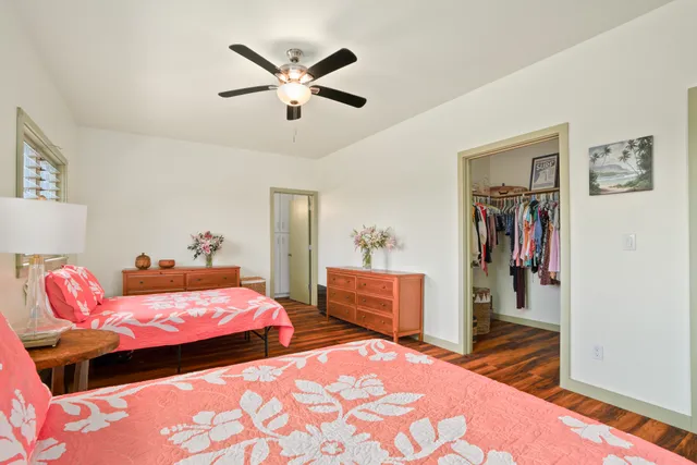 a bedroom with two beds and a chandelier