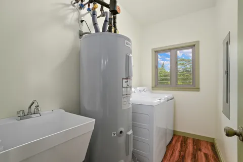 a bathroom with a sink and mirror with bathtub