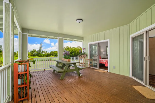 a living room with furniture floor to ceiling window and wooden floor