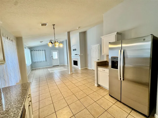 a view of a kitchen with a refrigerator