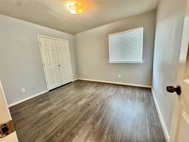 a view of a room with wooden floor and window