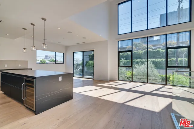 a kitchen with stainless steel appliances granite countertop a sink a stove and a refrigerator