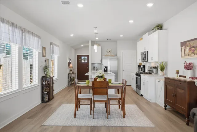 a dining room with furniture and a kitchen view