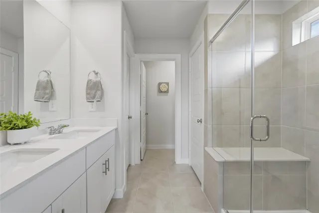 a bathroom with a shower sink and mirror