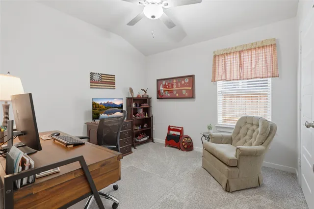 a livingroom with workspace and a window