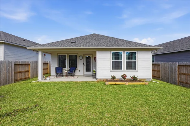 a view of a house with backyard porch and furniture