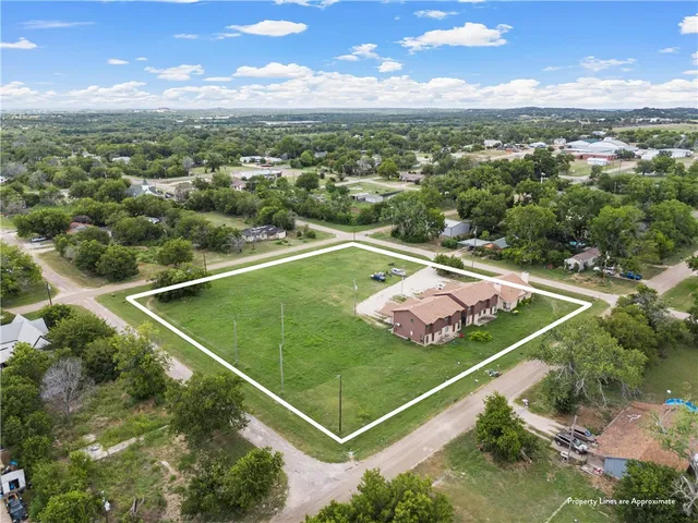 an aerial view of a house with a yard