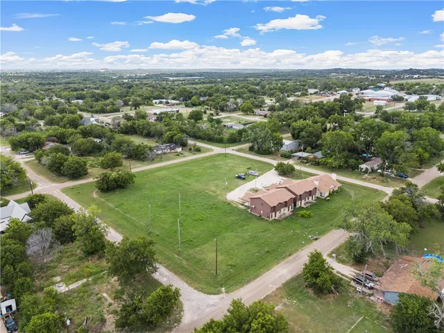 an aerial view of a golf course with parking space